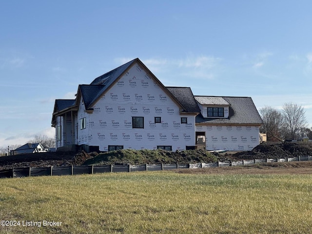 view of side of property with a yard