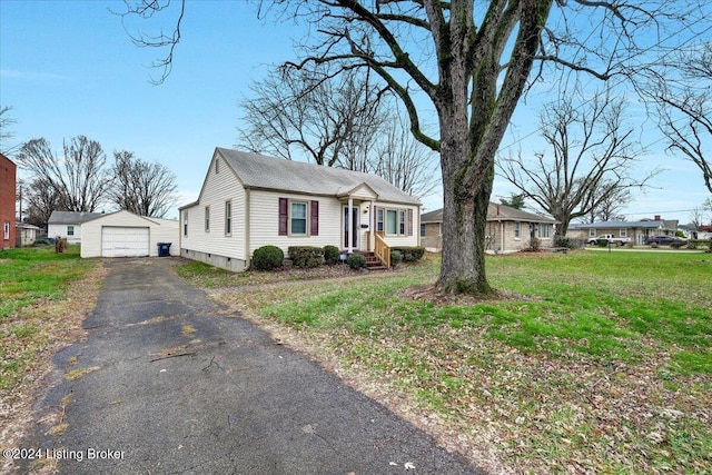 view of front of property with an outbuilding, a garage, and a front yard