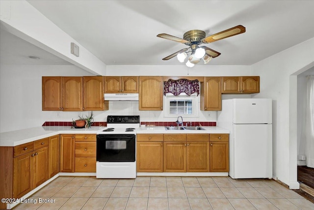 kitchen featuring sink, white refrigerator, light tile patterned floors, electric range, and ceiling fan