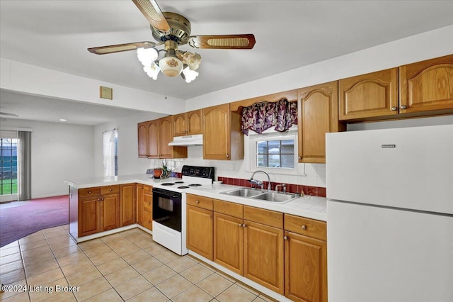 kitchen featuring sink, light tile patterned floors, white refrigerator, kitchen peninsula, and electric stove