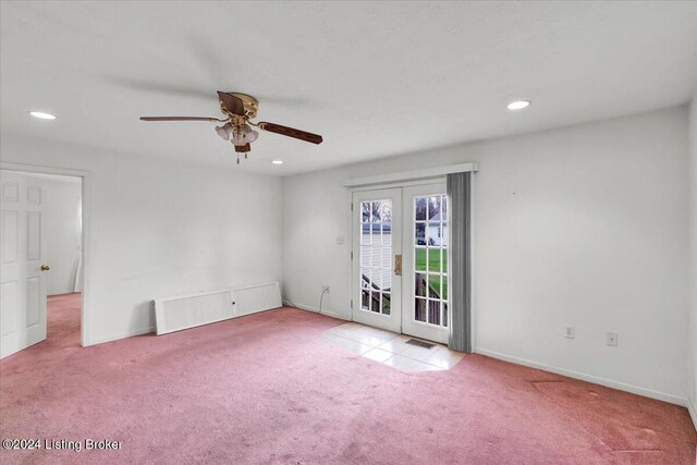 empty room with french doors, ceiling fan, and light carpet