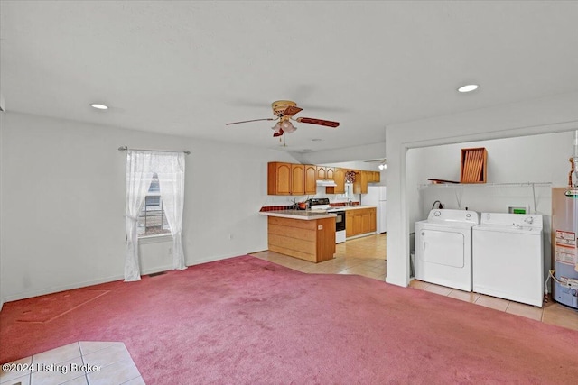 interior space with light carpet, water heater, washer and dryer, and ceiling fan