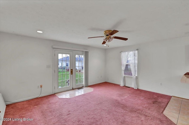 carpeted empty room with french doors and ceiling fan