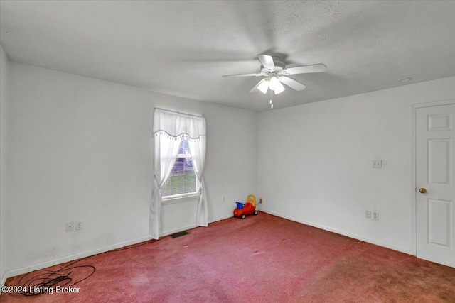 spare room with ceiling fan, carpet, and a textured ceiling