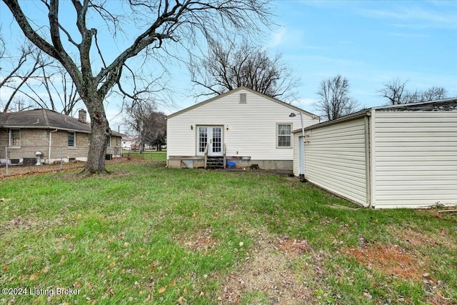 rear view of property with a yard