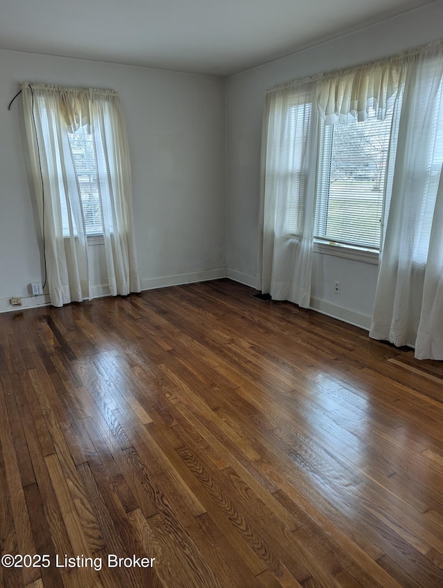 spare room with dark hardwood / wood-style floors