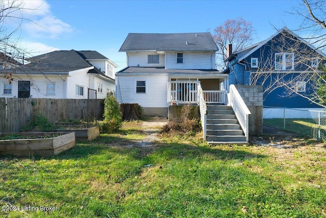 rear view of house with a lawn and a deck