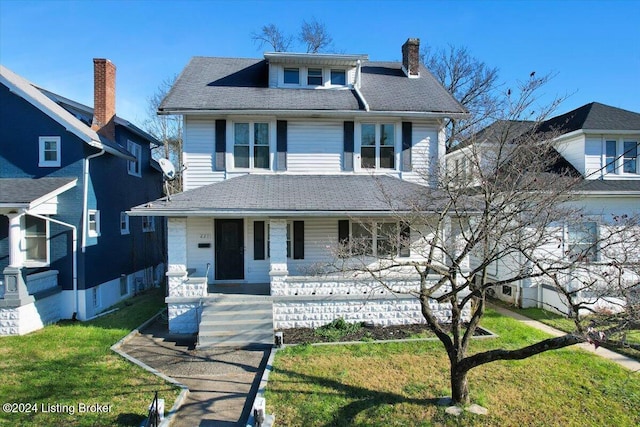 view of front of house with covered porch and a front yard