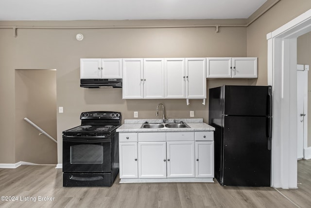 kitchen featuring white cabinetry, sink, black appliances, and light hardwood / wood-style floors