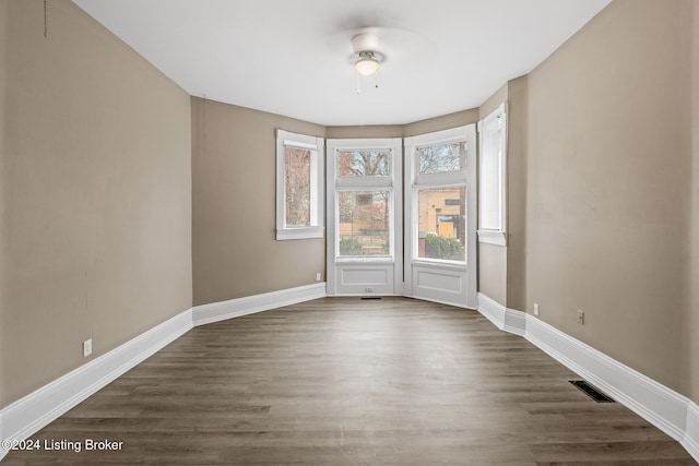 unfurnished room featuring dark hardwood / wood-style floors and ceiling fan