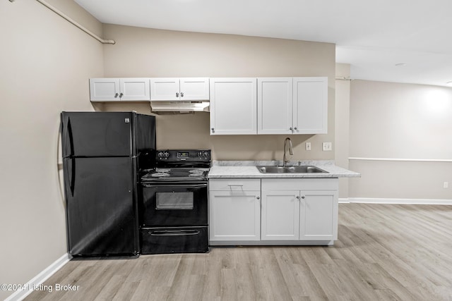 kitchen with white cabinetry, sink, lofted ceiling, black appliances, and light wood-type flooring