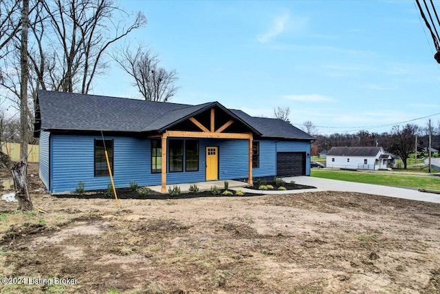 view of front facade featuring covered porch and a garage