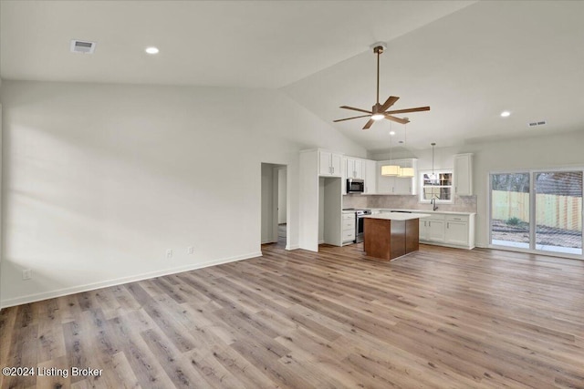 unfurnished living room with ceiling fan, sink, high vaulted ceiling, and light hardwood / wood-style floors