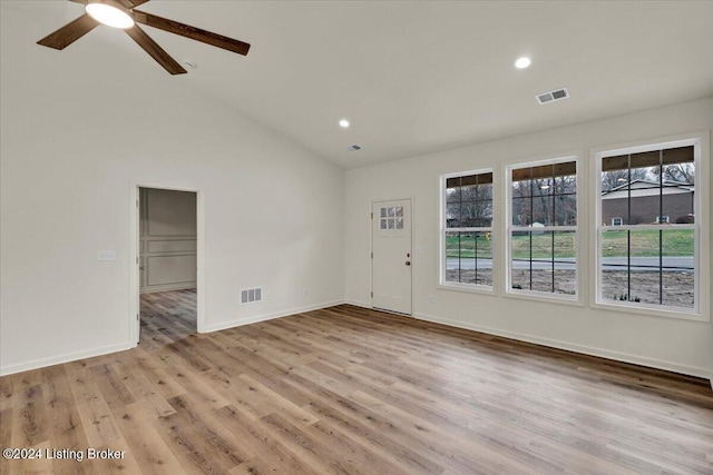 unfurnished room featuring ceiling fan, vaulted ceiling, and light wood-type flooring