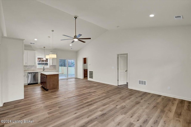 unfurnished living room with ceiling fan, sink, high vaulted ceiling, and light hardwood / wood-style flooring