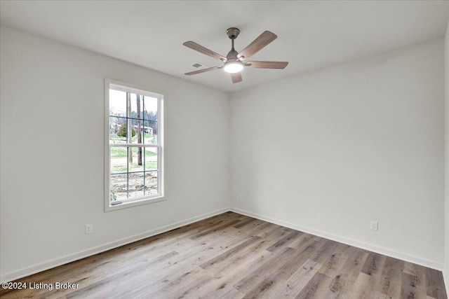 spare room featuring light wood-type flooring and ceiling fan