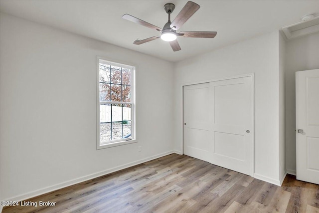 unfurnished bedroom with a closet, ceiling fan, and light hardwood / wood-style flooring