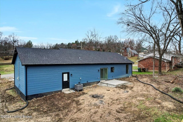 back of property with central AC