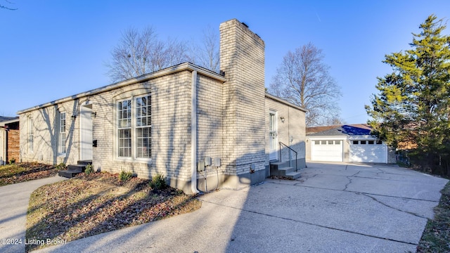 view of side of property with a garage and an outdoor structure