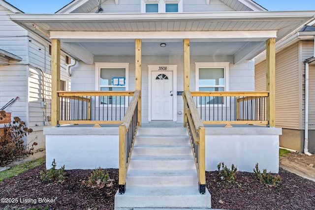 view of exterior entry with a porch