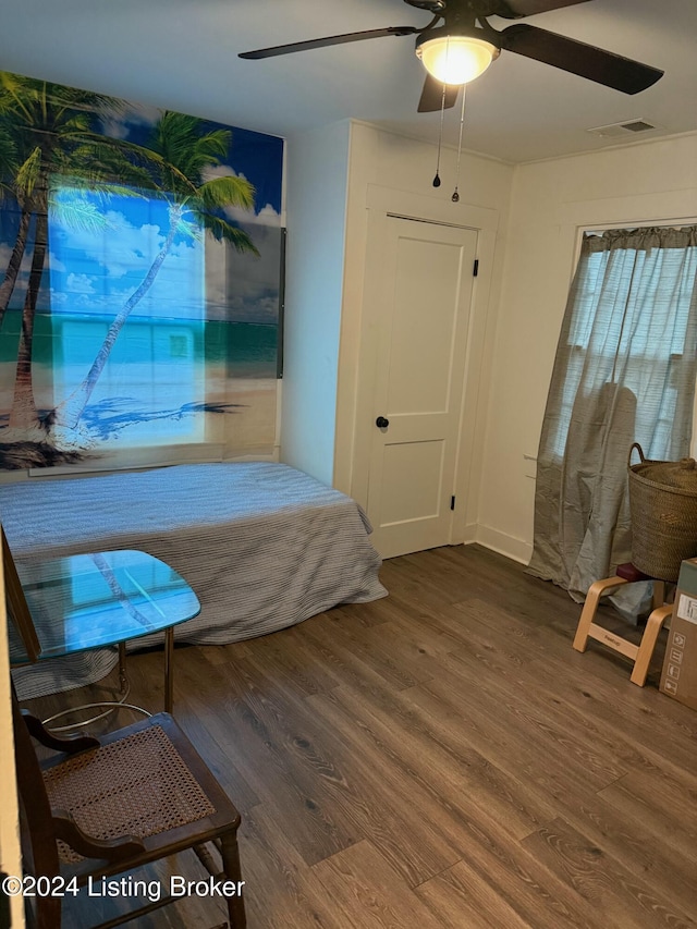 bedroom with ceiling fan and dark hardwood / wood-style flooring