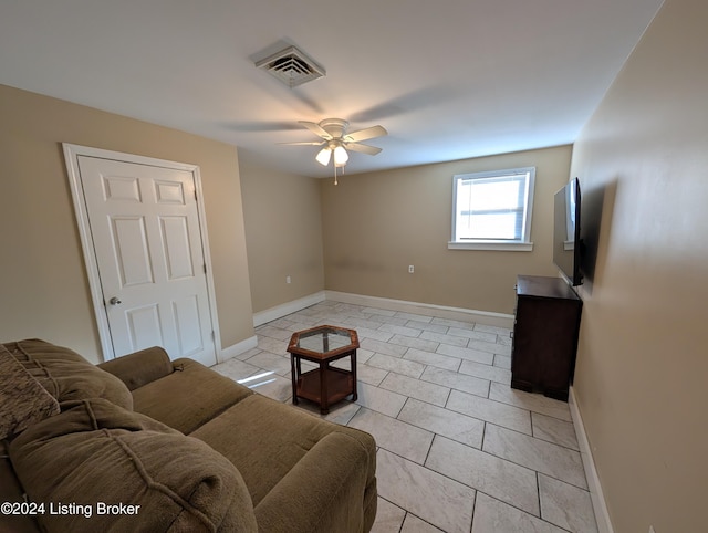 tiled living room featuring ceiling fan