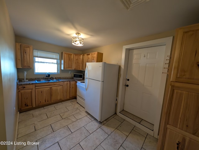 kitchen featuring white appliances and sink