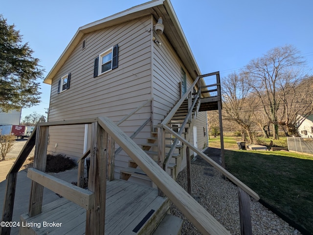 view of home's exterior with a lawn and a wooden deck