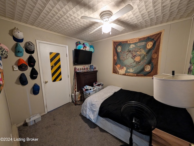 carpeted bedroom featuring ceiling fan and ornamental molding