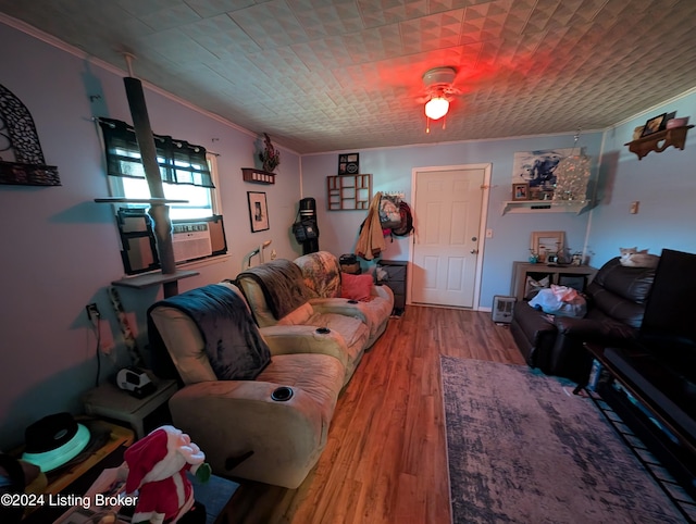 living room featuring hardwood / wood-style flooring, cooling unit, and ornamental molding