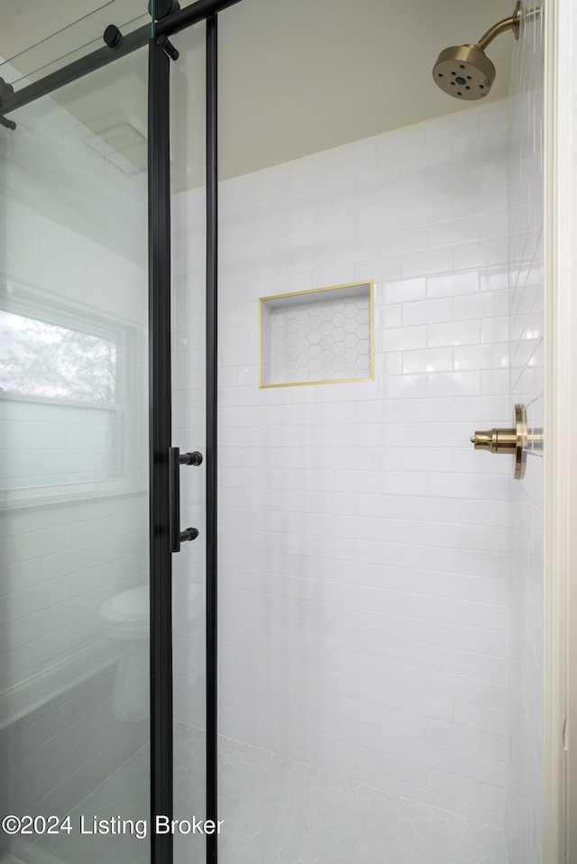 bathroom featuring a shower with shower door