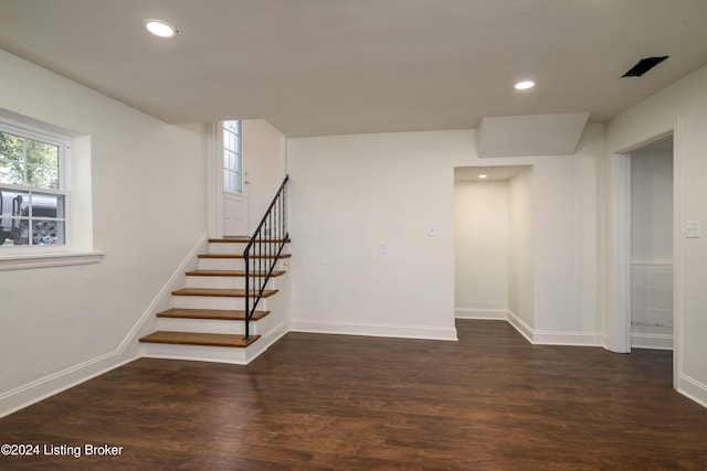 basement with dark hardwood / wood-style floors