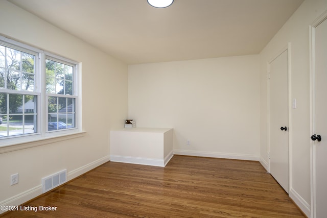 spare room with dark hardwood / wood-style floors