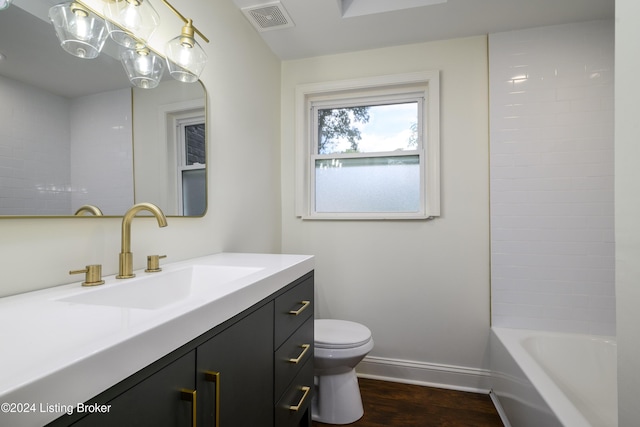 full bathroom featuring hardwood / wood-style flooring, vanity,  shower combination, and toilet