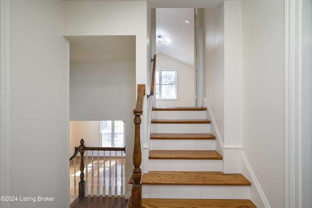 stairs featuring vaulted ceiling