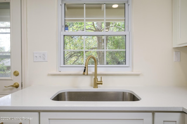 kitchen featuring sink, white cabinets, and a healthy amount of sunlight