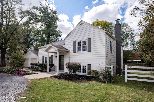 view of front of property featuring a garage and a front lawn