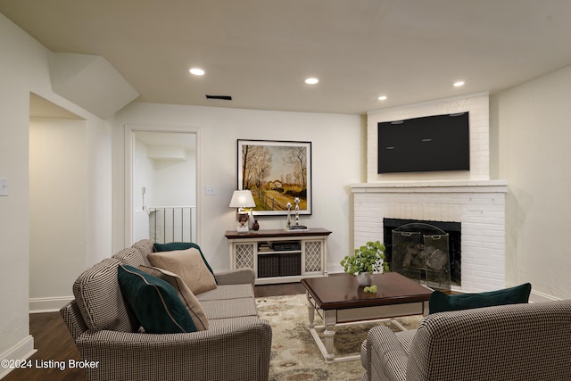 living room with a fireplace and dark hardwood / wood-style flooring