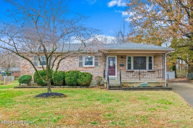 view of front of home with a front yard and a porch