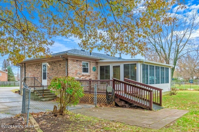 view of front of home with a sunroom and a deck