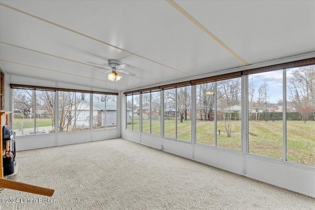 unfurnished sunroom featuring ceiling fan