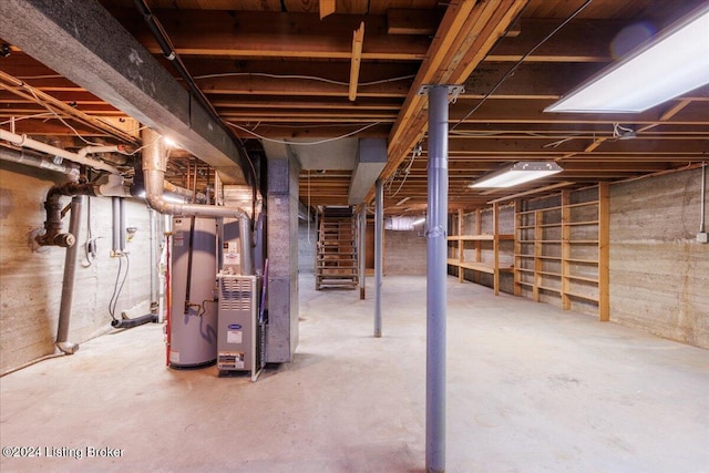 basement featuring gas water heater and heating unit