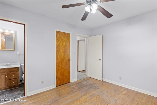 unfurnished bedroom with ensuite bath, ceiling fan, light hardwood / wood-style flooring, and sink