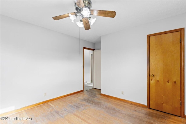 empty room with ceiling fan and light hardwood / wood-style floors