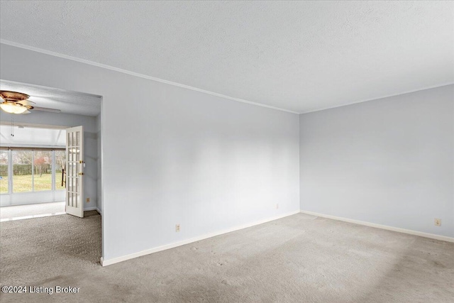 empty room with crown molding, carpet floors, a textured ceiling, and ceiling fan