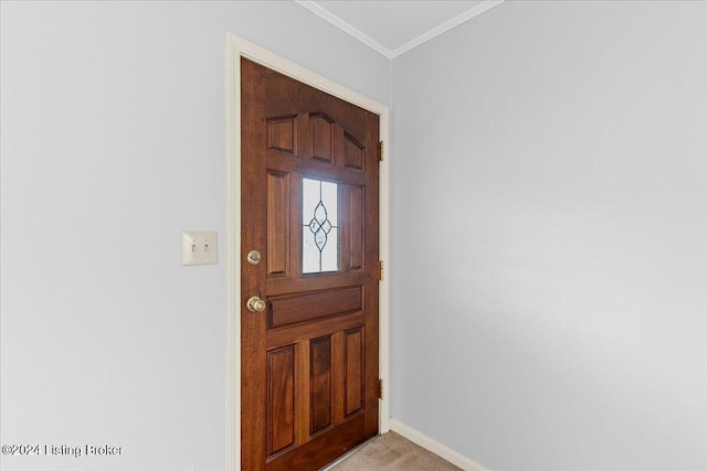 entryway featuring ornamental molding and light carpet