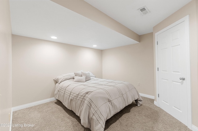 bedroom featuring light colored carpet