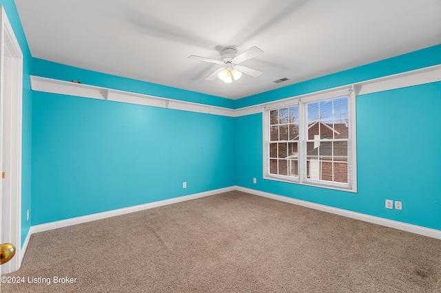 spare room featuring carpet and ceiling fan