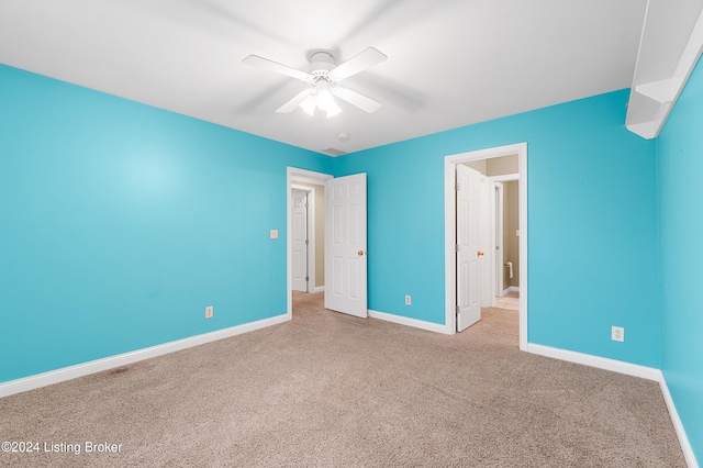 unfurnished bedroom with ceiling fan and light colored carpet