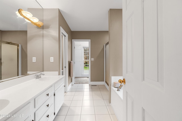 bathroom featuring tile patterned floors, vanity, and walk in shower